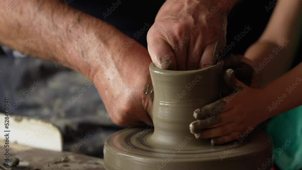 4K video during a pottery workshop. A potter teaches a child to make a clay pot. Great hobby and education activity for students. 4K video during a pottery workshop. A potter teaches a child to make a clay pot. Great hobby and education activity for students.
