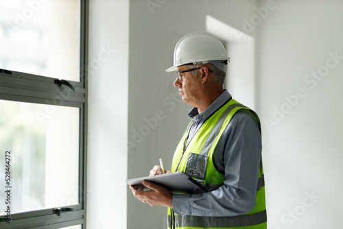 Professional senior engineer builder old man work looking at contract detail document paper