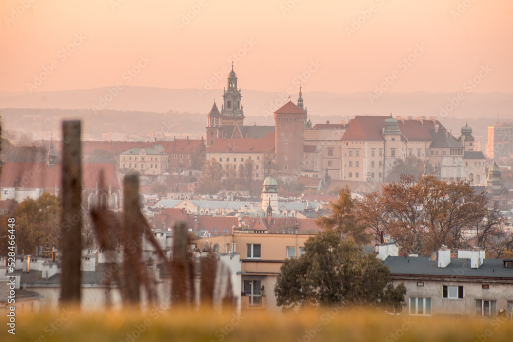 Wawel Castle and Cracow city during sunset. Photography taken from Krakus Mound. Pastel and soft colors.