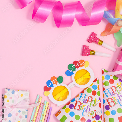 Birthday party copy space background with party accessories on pastel pink theme. Flat lay