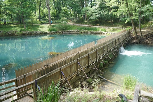 Beautiful blue water of a natural spring by a dam near Blue Spring Heritage Center, Eureka Springs, Arkansas, U.S photo