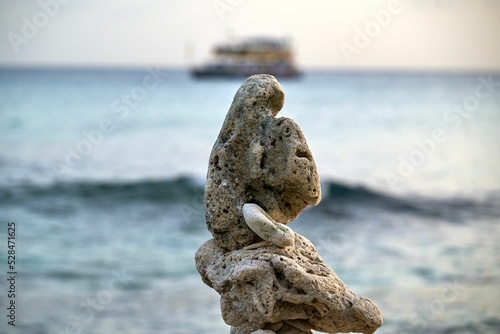 Photography Close-up shot of balanced rocks near the water