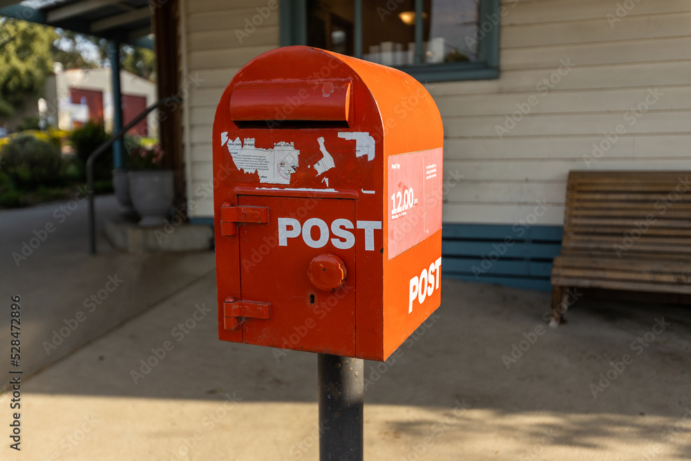 A red australia post letter box stripped of all branding and logos. A red australia post letter box stripped of all branding and logos.