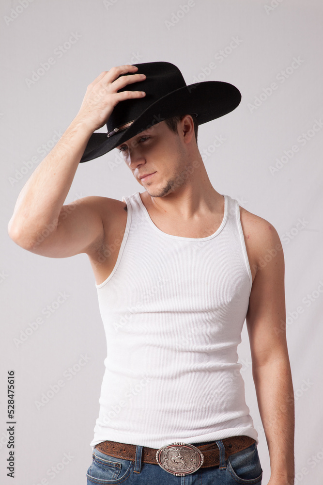 Handsome man in undershirt and western hat Handsome man in undershirt and western hat