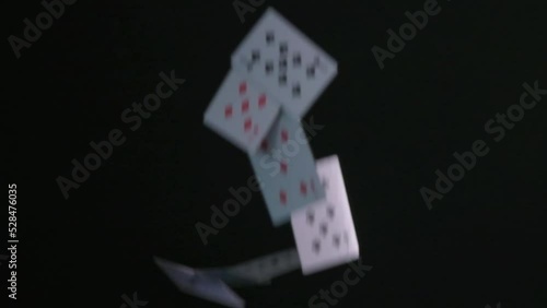 Drop a deck of playing cards on a black background. Flying solitaire cards in slow motion. photo