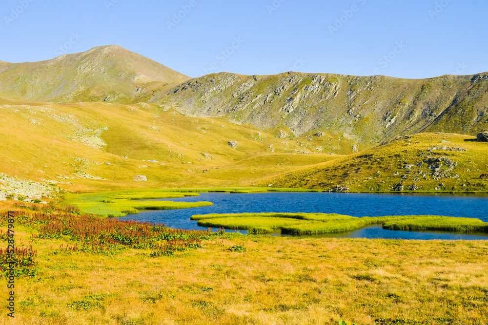 Small pristine mountain lake with horse on hiking trail to black rock lake in Lagodekhi national park.Hidden spots gems in Georgia