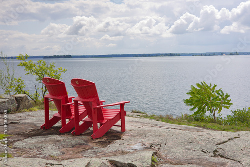 Photography Red Adirondack chairs overlooking the St. Lawrence River