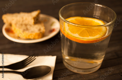 slice of orange in glass of water on the table