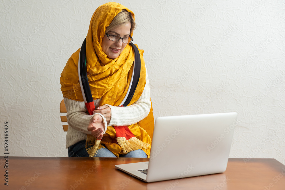 Portrait of woman, UAE national flag, laptop Portrait of woman, UAE national flag, laptop
