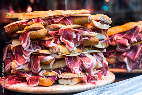 mouth watering sandwiches with jamon laid out in a slide on shop window