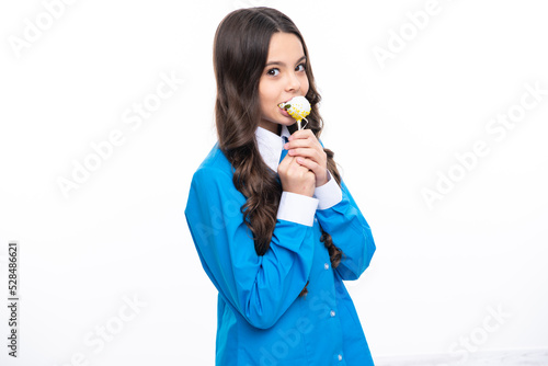 Teenager girl eating sugar lollypop. Candy and sweets for kids. Child eat lollipop popsicle over white isolated background. Yummy caramel, candy shop.