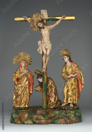 statue of Jesus crucified on calvary with Virgin Mary and Saint John