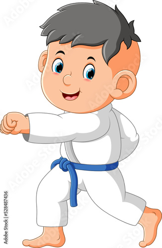 The little boy is doing taekwondo and showing the hit