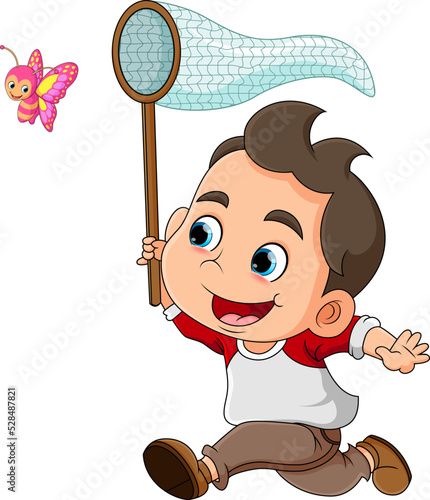 The little boy is running to catch a medium flying butterfly and so happy