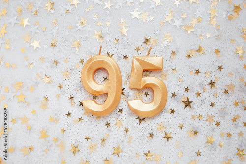 Number 95 ninety five golden celebration birthday candle on Festive Background. ninety five years birthday. concept of celebrating birthday, anniversary, important date, holiday