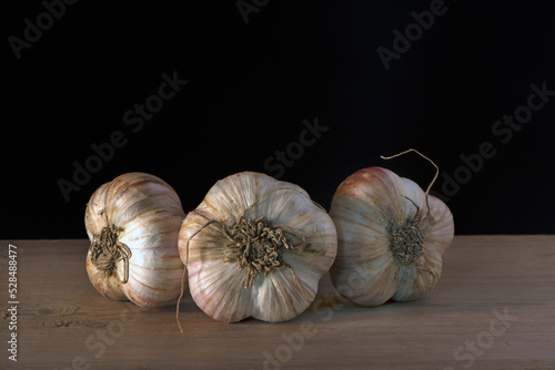 Wallpaper Mural heads of young garlic on a wooden table Torontodigital.ca