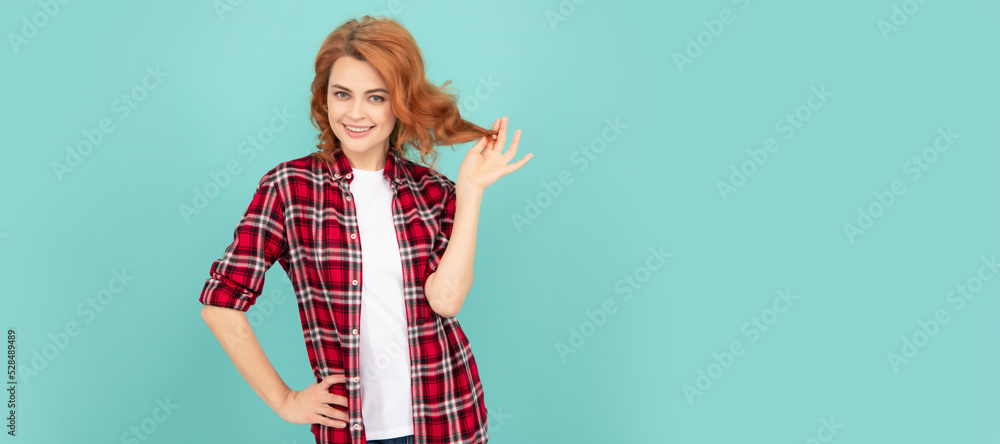 smiling redhead girl in checkered shirt on blue background. Woman isolated face portrait, banner with mock up copyspace. smiling redhead girl in checkered shirt on blue background. Woman isolated face portrait, banner with mock up copyspace.