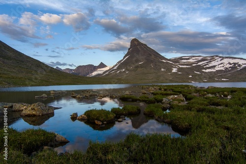 Beautiful shot of the Kyrkja Mountain against a cloudy sky at Jotunheimen National Park