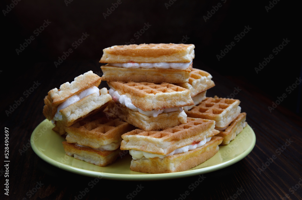 Viennese waffles on a yellow plate. Plate with waffles. Viennese waffles on a yellow plate. Plate with waffles.