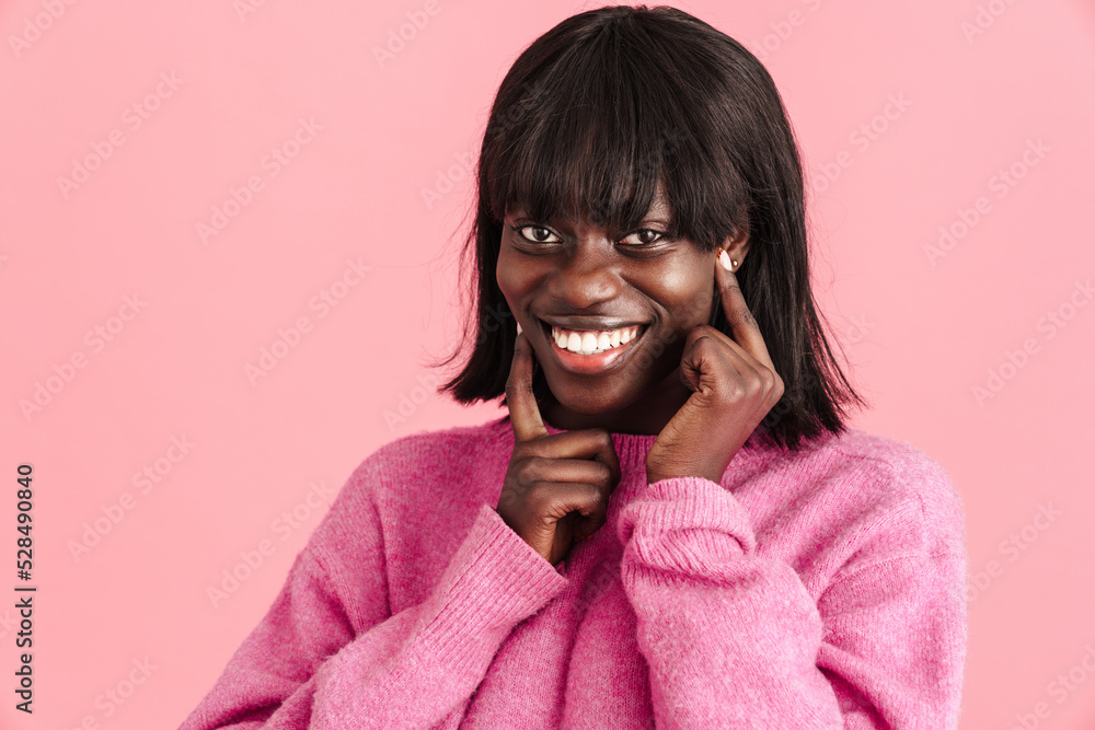 Young beautiful happy smiling african lady in pink sweater Young beautiful happy smiling african lady in pink sweater