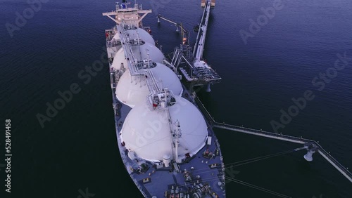 Aerial of Liquified Natural Gas LNG carrier moored to a small gas terminal. Fuel crisis. Sanctions photo