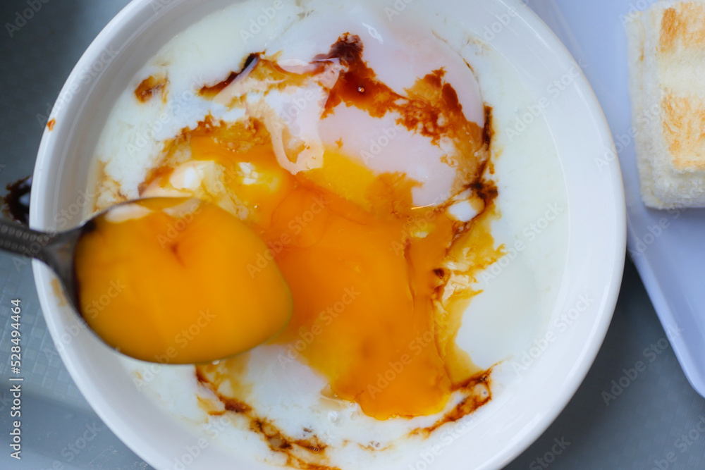 spoon pick soft boiled eggs in the plate close up , spoon pick soft boiled eggs in the plate close up ,
