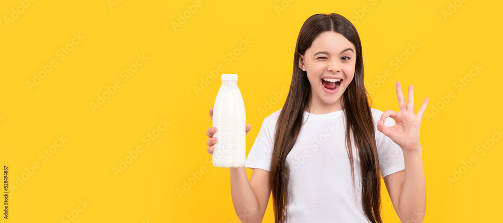 winking child hold dairy beverage product. teen girl going to drink milk. Horizontal poster of isolated child face, banner header, copy space. winking child hold dairy beverage product. teen girl going to drink milk. Horizontal poster of isolated child face, banner header, copy space.