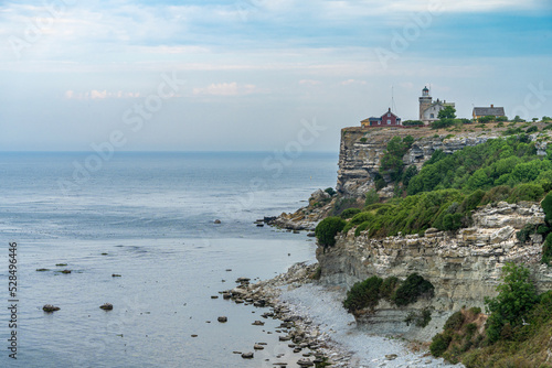 Sea coast view with lighthouse on the rock фототапет