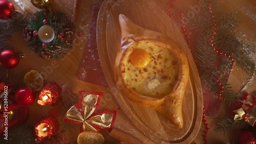 traditional georgian adjarian khachapuri with suluguni cheese, egg yolk, butter photo