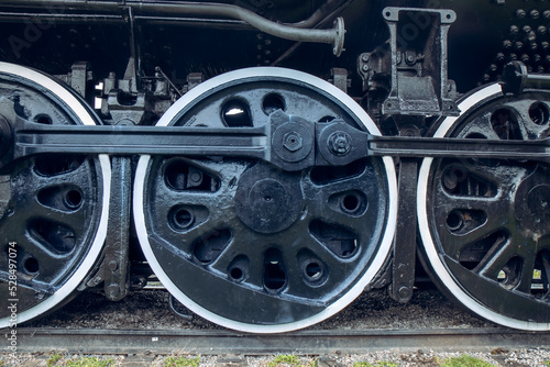 Steam locomotive wheels and connecting rods on a vintage train, daytime, nobody
