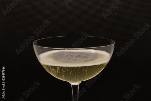 Sparkling wine Martini Asti in a glass on a black background