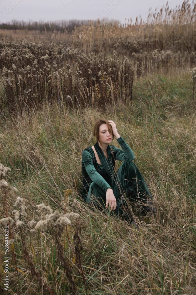 Autumn fashion outdoor portrait of young woman in emerald green set. Comfortable and trendy long sleeved shirt and trousers handmade from plush velvet
