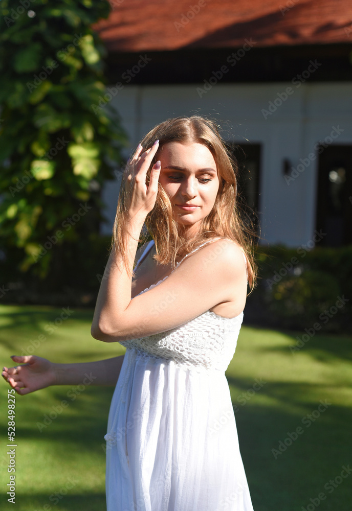 Portrait of beautiful Belarus woman half Ukrainian in white dress