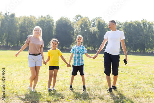 happy family playing in the green field