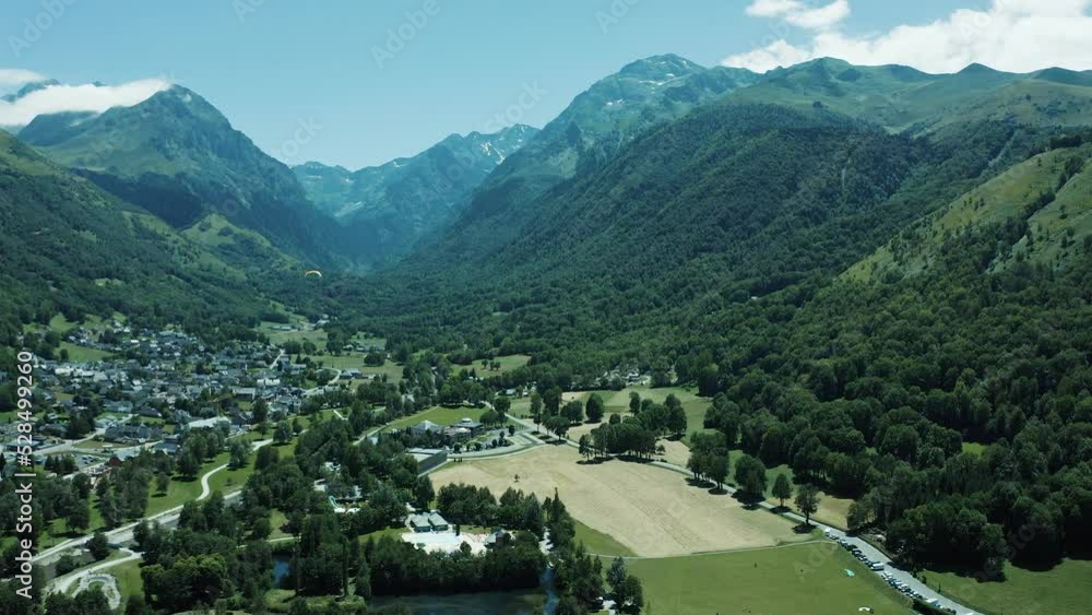 4K aerial shot of a forest and mountains in clouds 