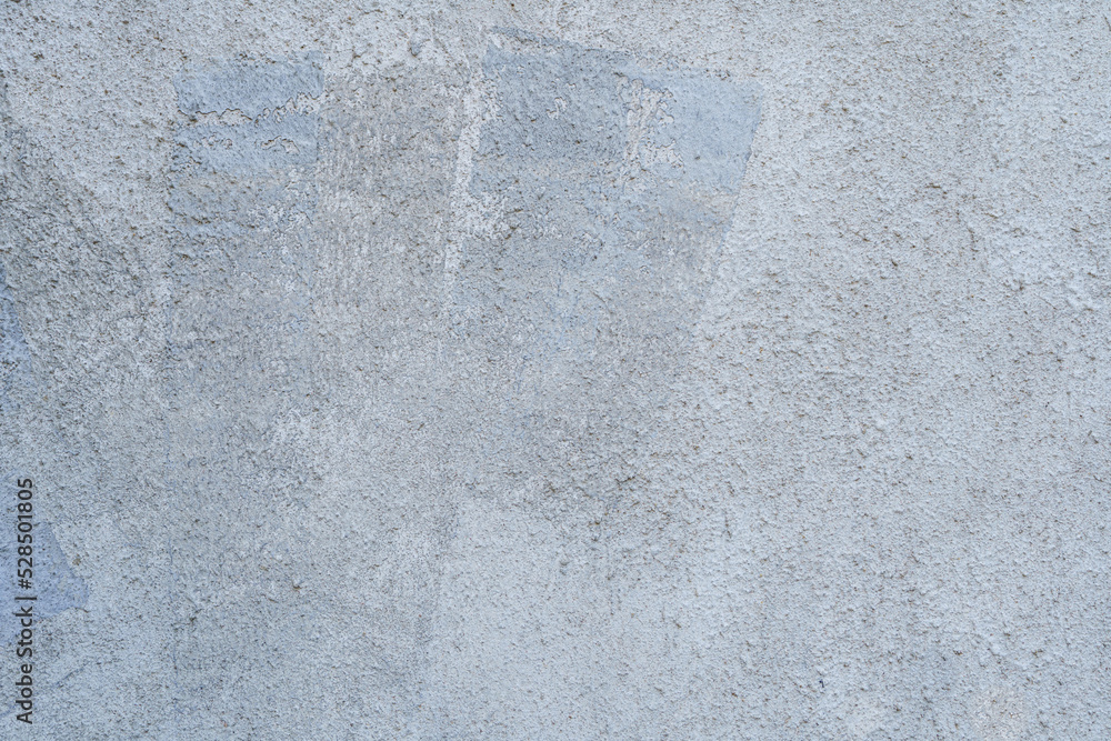 Fototapeta premium Uneven rough patterned gray cement wall, plaster wall background texture