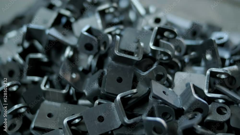 Close-up - A Lot Of Newly Made Metal Parts In A Pile For Further Processing. Concept Of Manufacturing Factory Parts Close-up - A Lot Of Newly Made Metal Parts In A Pile For Further Processing. Concept Of Manufacturing Factory Parts