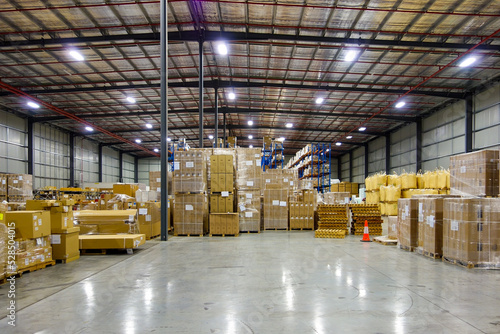 Interior of logistics warehouse with full of big cartons.