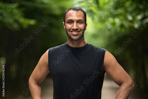Handsome sporty black man jogging in public park