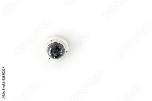 CCTV with the dome is hung on a white ceiling for circuit television guard protection..