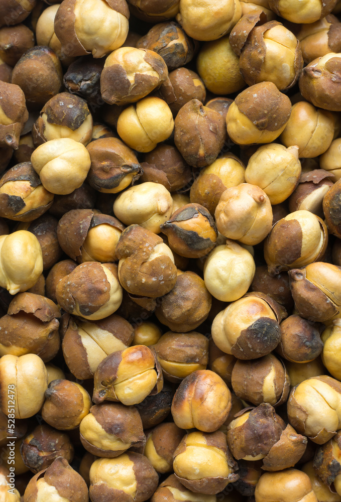 close-up of roasted and salted black chickpeas, also known as bengal gram or desi chickpea, traditional and native oil free snack of india, macro food background close-up of roasted and salted black chickpeas, also known as bengal gram or desi chickpea, traditional and native oil free snack of india, macro food background