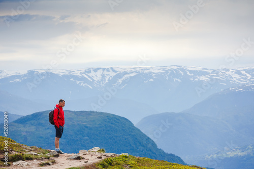 Hiker on the mountain trail. Sport and active life concept © olyphotostories