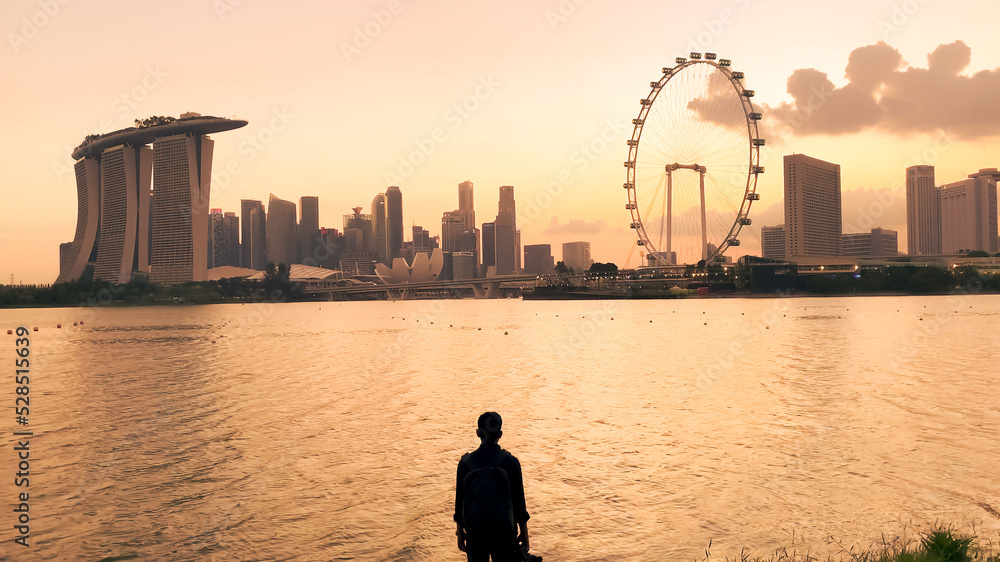 Fototapeta premium People exercising together in a city park at early evening, Singapore.
