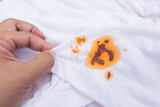 dirty barbeque sauce stain on cloth from daily life activity for cleaning concept. housework care living life of people. selective focus.