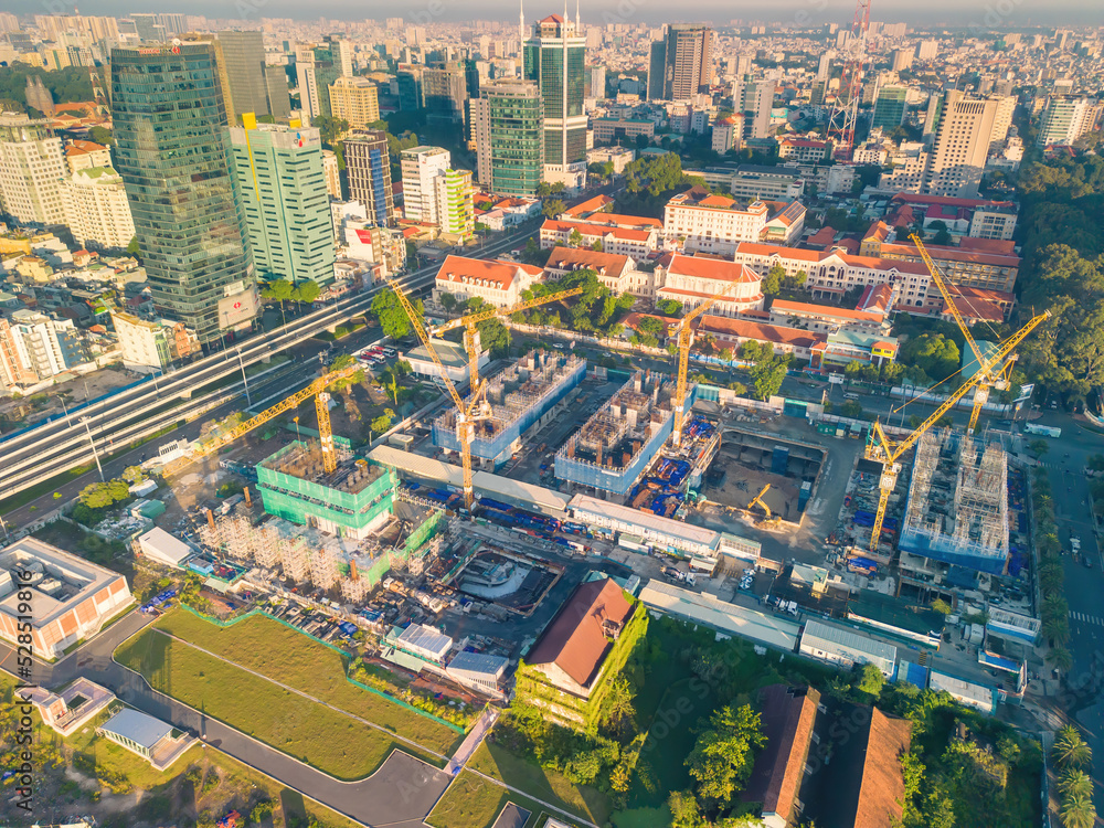 Aerial panoramic cityscape view of Ho Chi Minh city and Saigon river, Vietnam. Center of heart business at downtown with buildings and towers. Aerial panoramic cityscape view of Ho Chi Minh city and Saigon river, Vietnam. Center of heart business at downtown with buildings and towers.