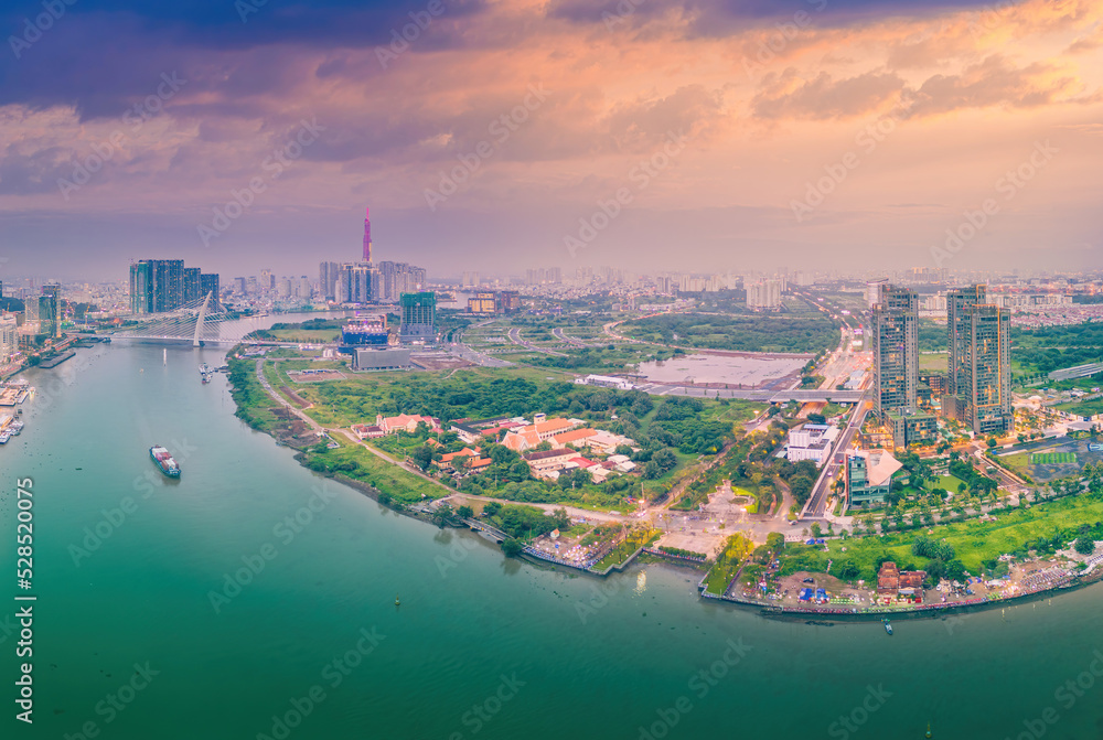 Obraz premium Aerial view of Ho Chi Minh City skyline and skyscrapers on Saigon river, center of heart business at downtown. Morning view. Far away is Landmark 81 skyscraper