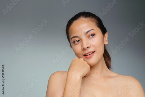 Beautiful Asian woman with natural makeup, facial treatment spa and beauty, Smiling beautiful woman standing over isolated background with copy space.