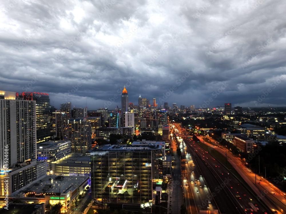  Midtown Atlanta Georgia,  Night lights and storm clouds with highway traffic. Drone shot.