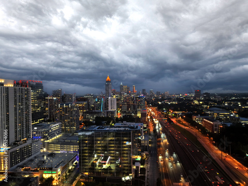 Midtown Atlanta Georgia, Night lights and storm clouds with highway traffic. Drone shot.