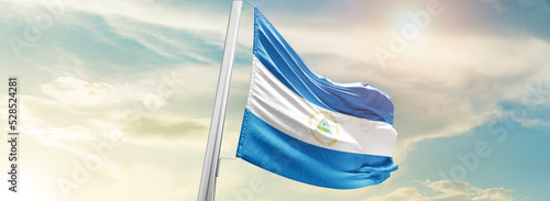 Obraz na płótnie Nicaragua national flag cloth fabric waving on the sky - Image